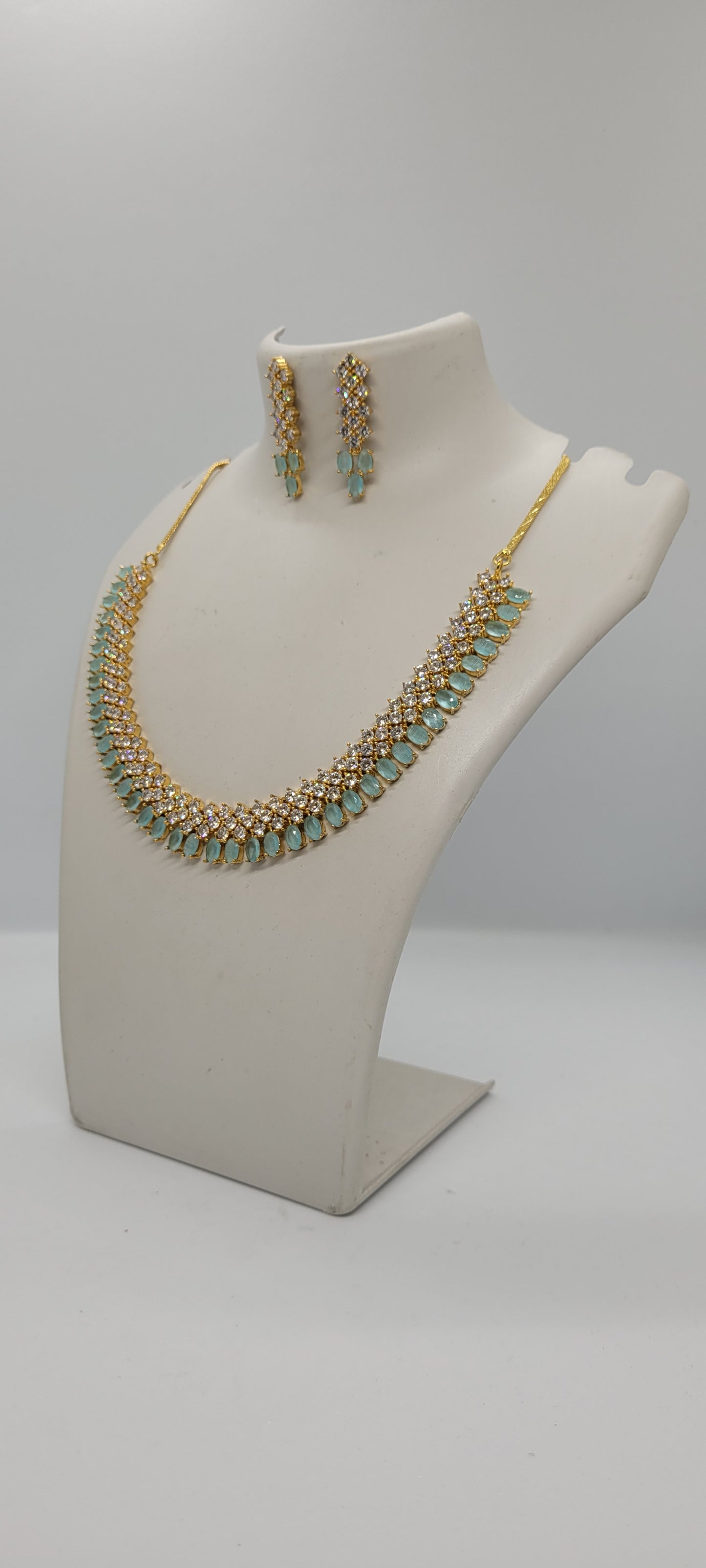 Golden Necklace Set with Light Teal Blue and White American Diamond Stones & Earrings1