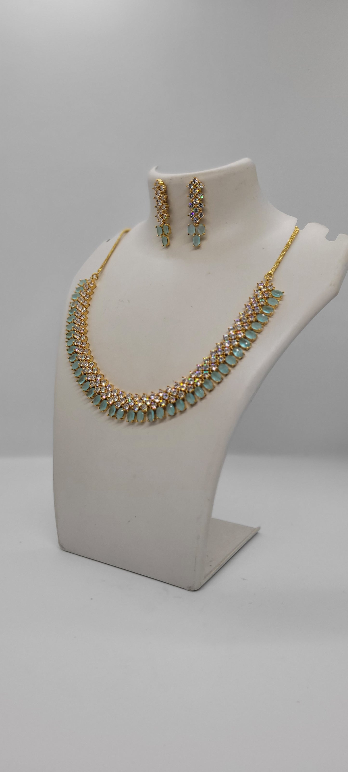 Golden Necklace Set with Light Teal Blue and White American Diamond Stones & Earrings1