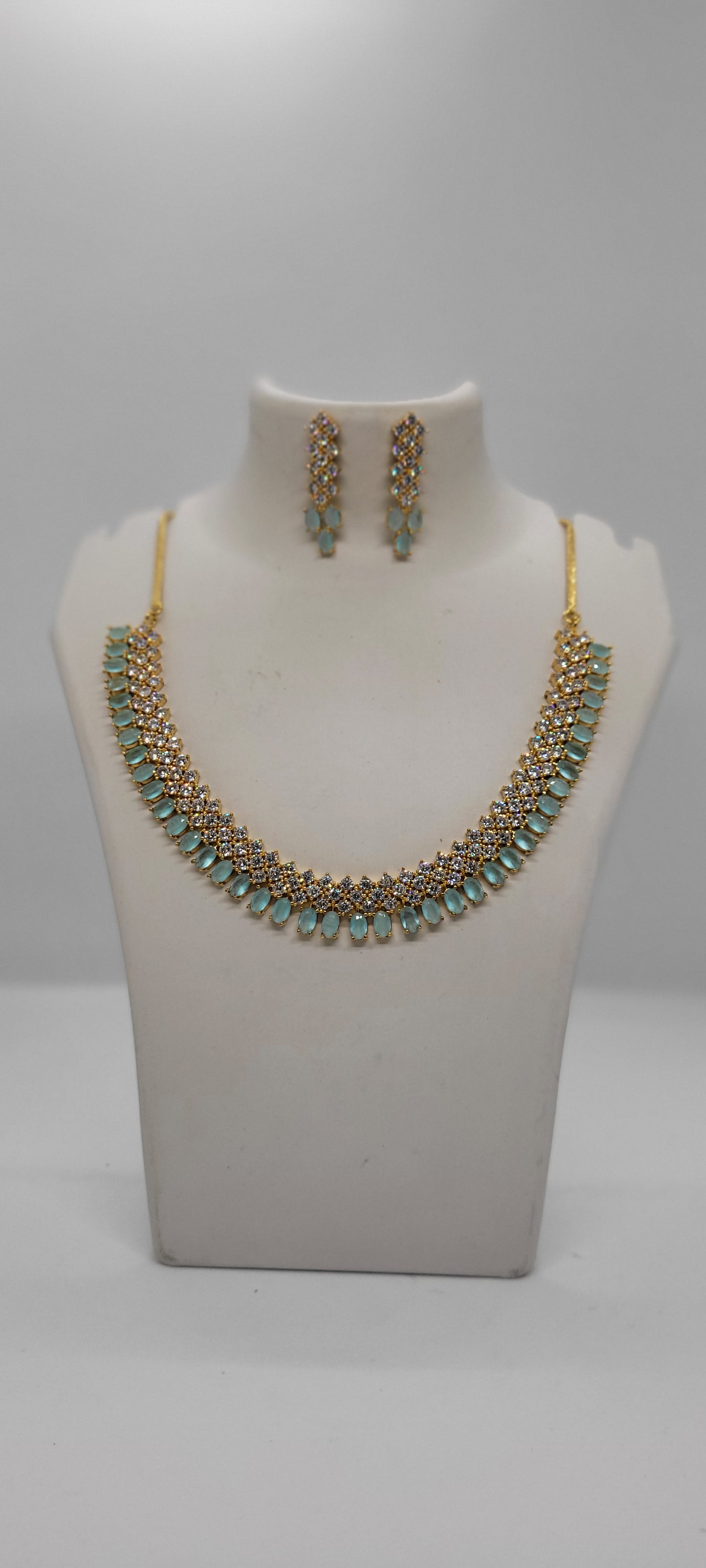 Golden Necklace Set with Light Teal Blue and White American Diamond Stones & Earrings1