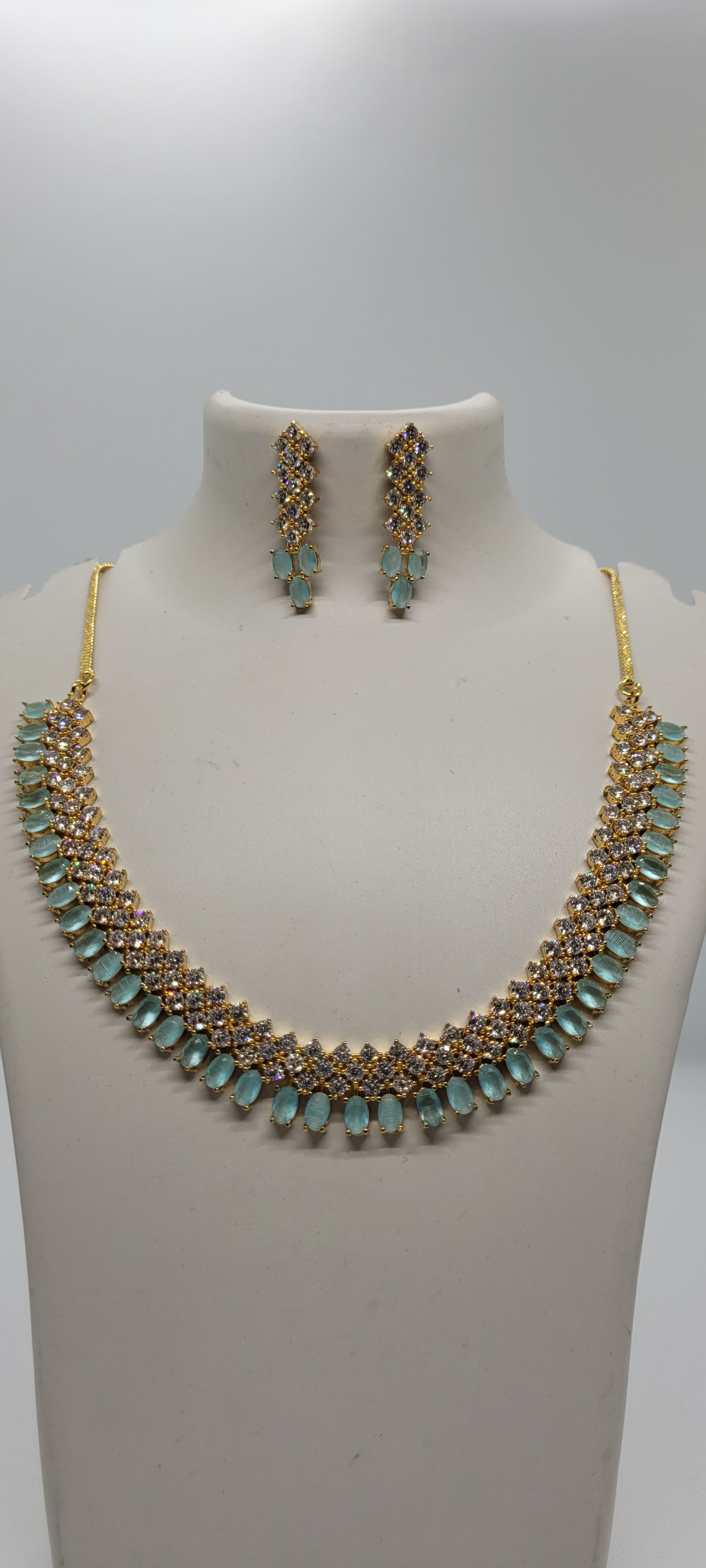 Golden Necklace Set with Light Teal Blue and White American Diamond Stones & Earrings1